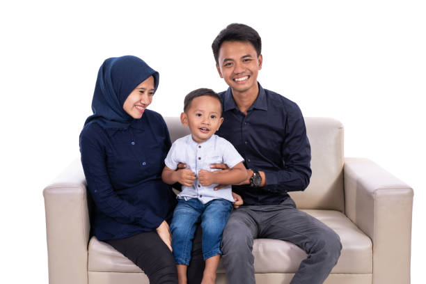 muslim father and mother with son isolated over white background