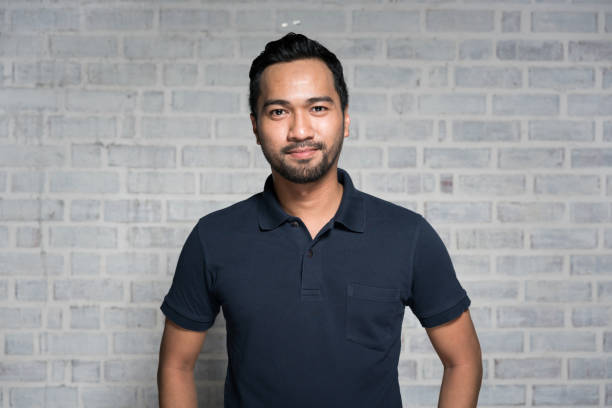 Portrait of a Malaysian man smiling and looking at camera.